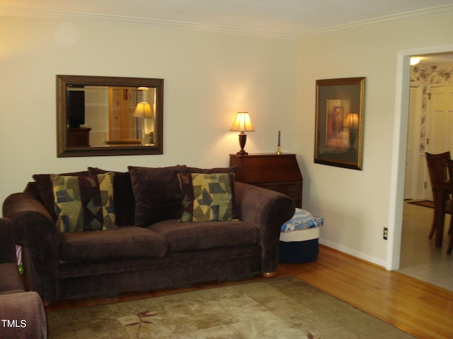 living room with light hardwood / wood-style floors and ornamental molding