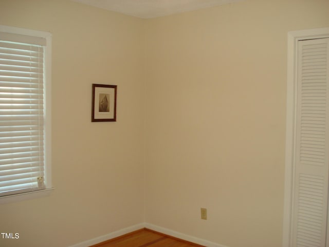 unfurnished room featuring hardwood / wood-style flooring