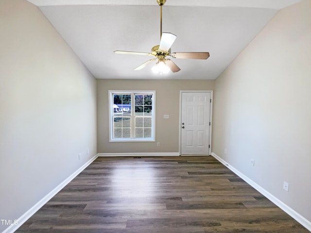 spare room featuring ceiling fan, vaulted ceiling, and dark wood-type flooring