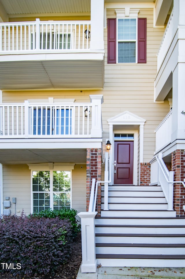 view of exterior entry featuring a balcony