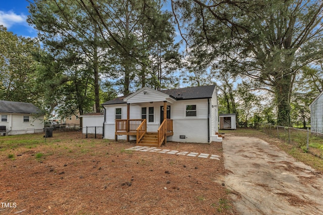 view of front of home featuring fence, crawl space, roof with shingles, and concrete driveway