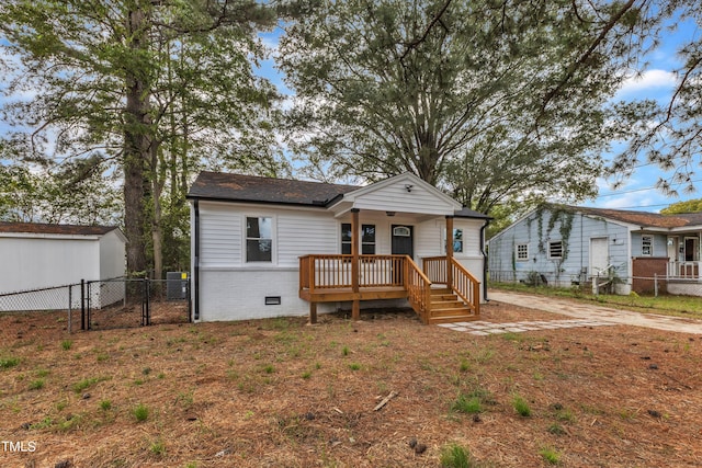 view of front of house with a gate, covered porch, crawl space, and fence