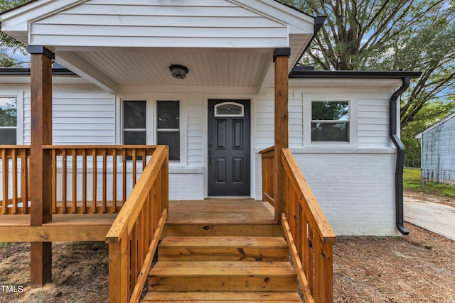 entrance to property featuring brick siding