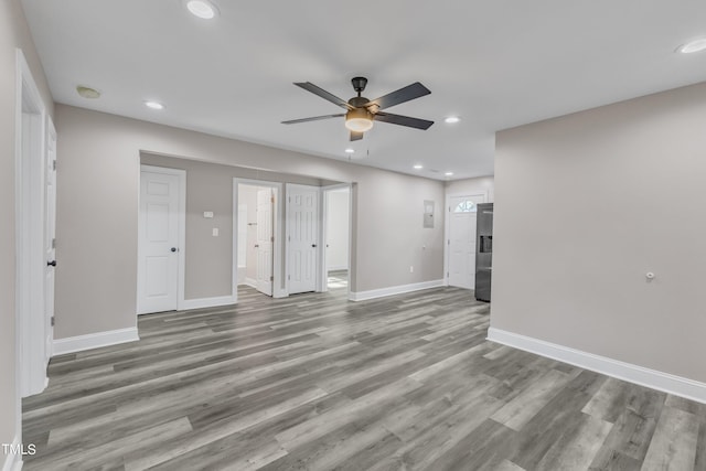 unfurnished living room featuring ceiling fan, baseboards, wood finished floors, and recessed lighting