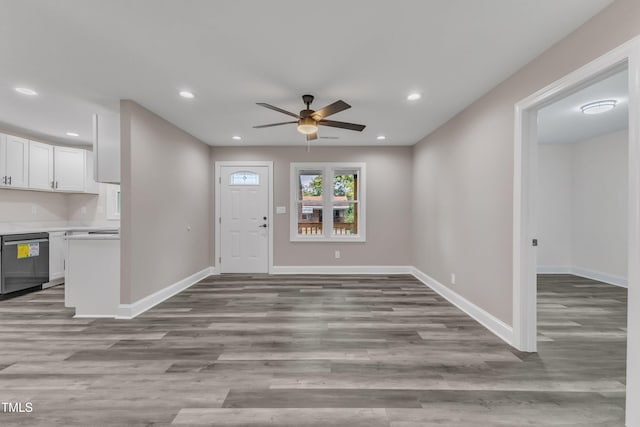 foyer entrance with ceiling fan and light wood-type flooring