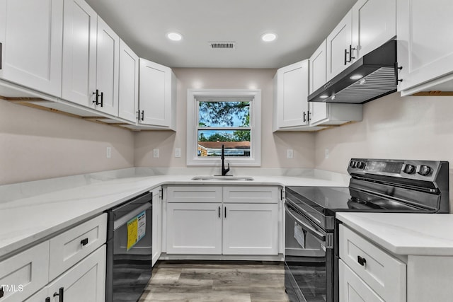 kitchen featuring white cabinets, light stone countertops, sink, and black appliances