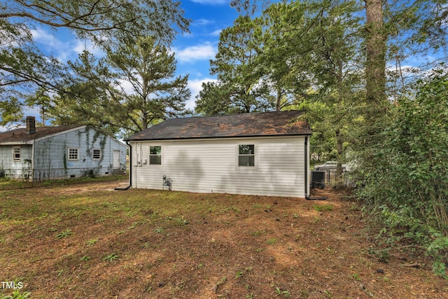 rear view of house with a yard