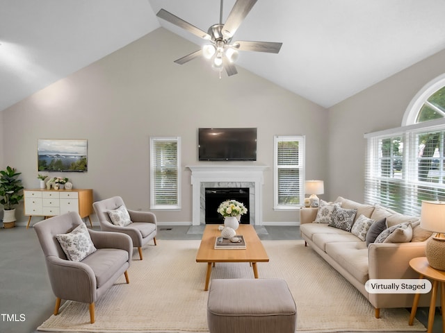 carpeted living room with high vaulted ceiling, a premium fireplace, and ceiling fan