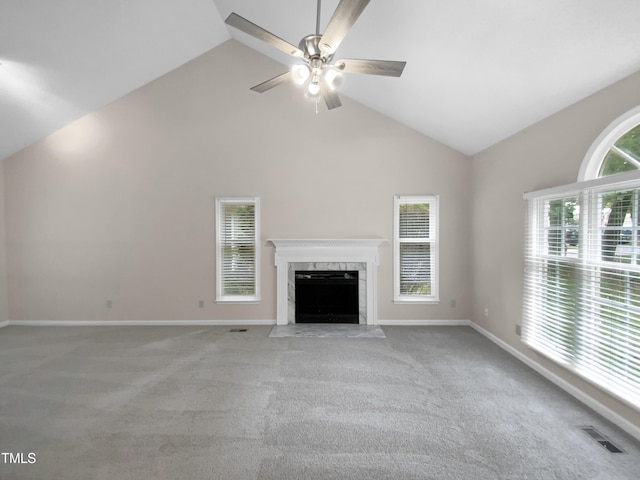 unfurnished living room with light carpet, a fireplace, high vaulted ceiling, and ceiling fan