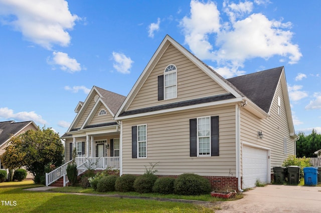 3806 Wyattwood Dr N, Wilson, NC 27896 - view of front of house with an attached garage, covered porch, concrete driveway, a front lawn, and roof with shingles