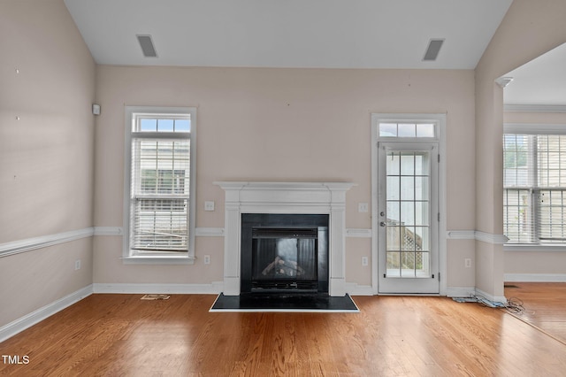 3806 Wyattwood Dr N, Wilson, NC 27896 - unfurnished living room featuring wood finished floors, baseboards, and plenty of natural light