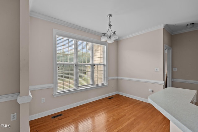 3806 Wyattwood Dr N, Wilson, NC 27896 - unfurnished dining area with crown molding, a notable chandelier, and a healthy amount of sunlight
