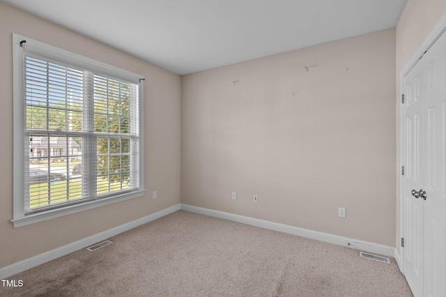 empty room featuring light colored carpet