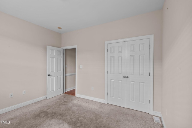 3806 Wyattwood Dr N, Wilson, NC 27896 - unfurnished bedroom featuring a closet, carpet flooring, visible vents, and baseboards