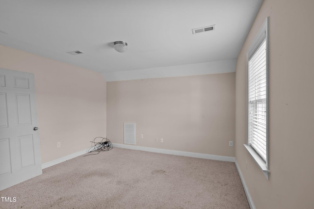 carpeted spare room featuring a wealth of natural light