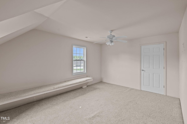 additional living space featuring carpet floors, vaulted ceiling, and ceiling fan