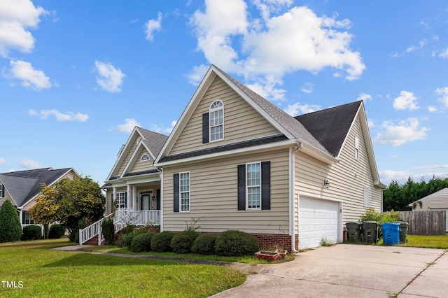 view of front facade with a porch, a garage, and a front yard