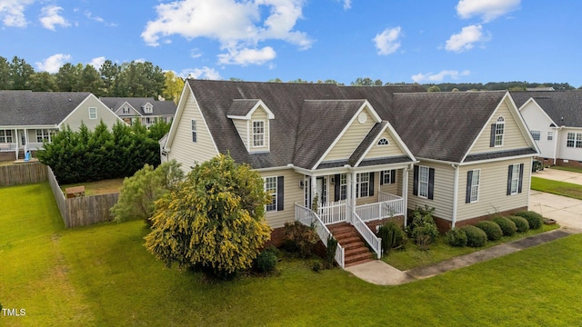 3806 Wyattwood Dr N, Wilson, NC 27896 - cape cod-style house featuring a front yard, fence, covered porch, and stairs