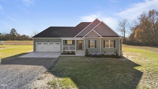 view of front of house featuring covered porch, a garage, and a front yard