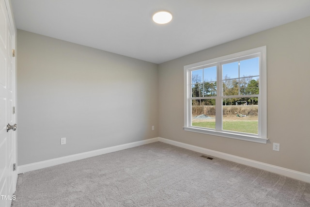 spare room featuring light colored carpet