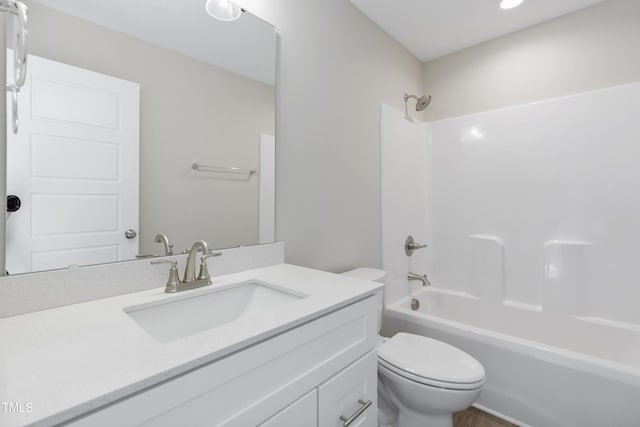 full bathroom featuring bathtub / shower combination, vanity, and toilet