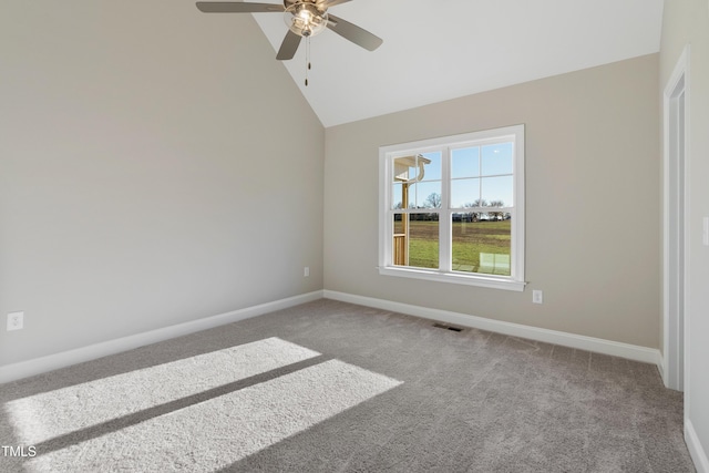 carpeted empty room featuring vaulted ceiling and ceiling fan