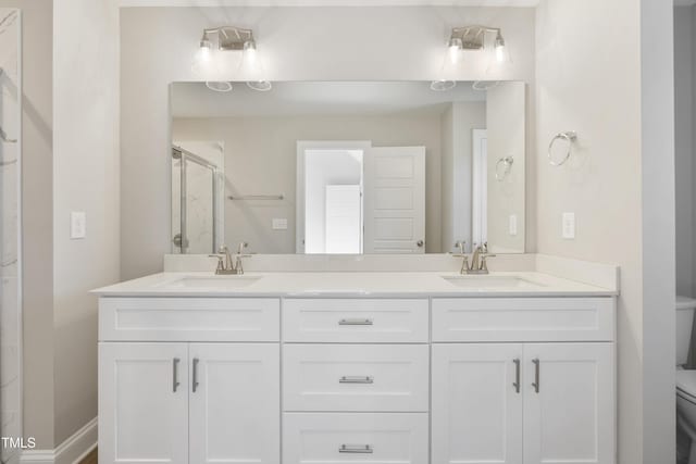 bathroom with vanity, toilet, and an enclosed shower