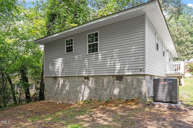 view of side of property featuring central air condition unit