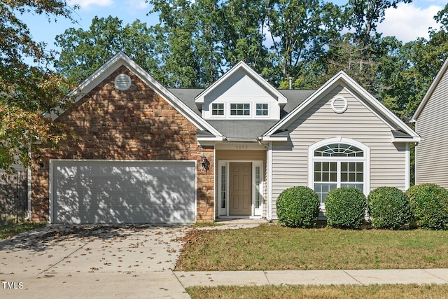 view of front of property with a front yard and a garage