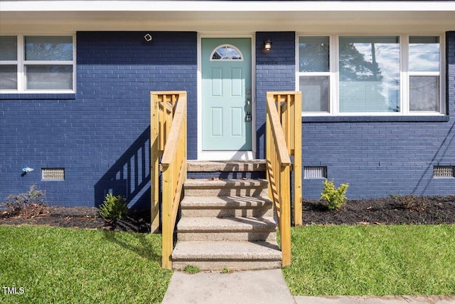 property entrance with a yard