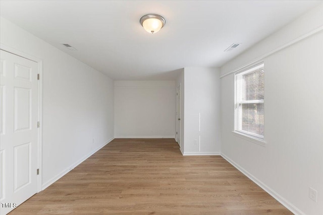 unfurnished room with light wood-type flooring