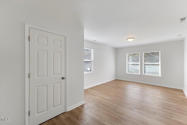 empty room with light hardwood / wood-style floors