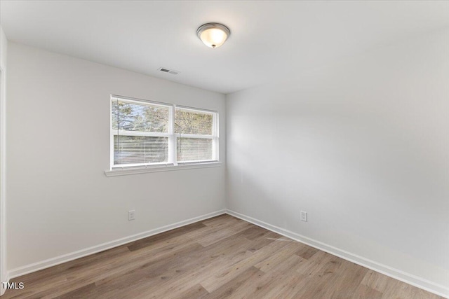 empty room with light hardwood / wood-style floors