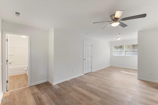 empty room with light hardwood / wood-style floors and ceiling fan