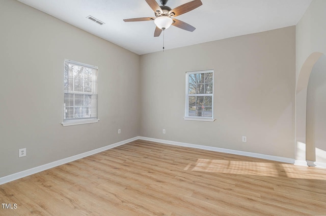 spare room with light wood-type flooring and ceiling fan