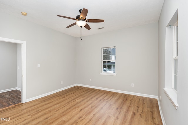 empty room featuring ceiling fan and light hardwood / wood-style flooring