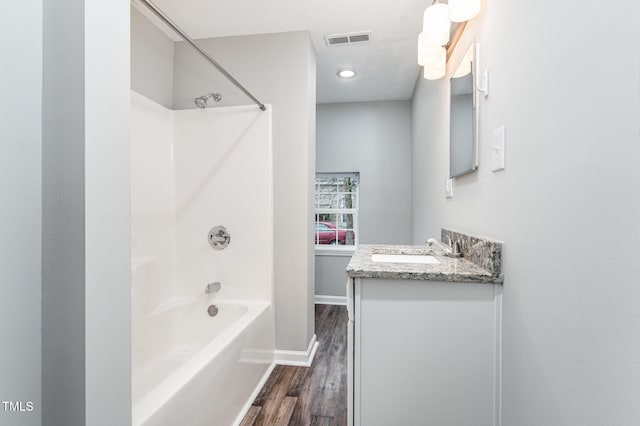 bathroom with shower / bathing tub combination, wood-type flooring, and vanity