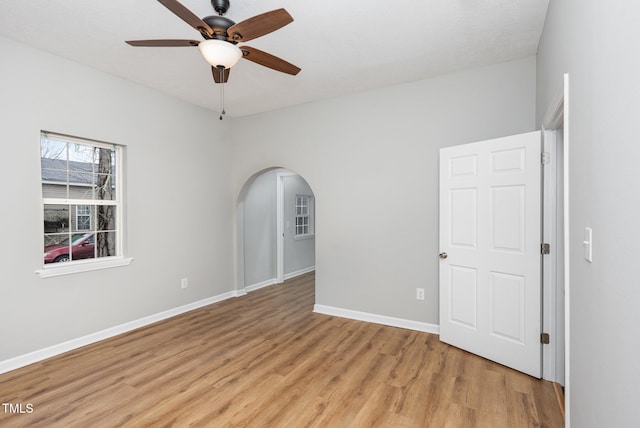 empty room featuring ceiling fan and light hardwood / wood-style flooring