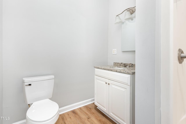 bathroom with vanity, wood-type flooring, and toilet