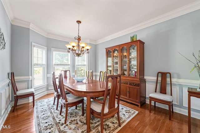 dining space featuring ornamental molding, a chandelier, and dark hardwood / wood-style floors