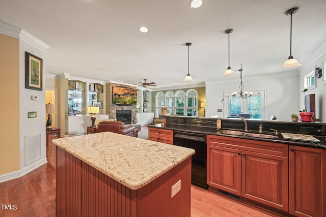 kitchen featuring sink, dishwasher, ornamental molding, and light wood-type flooring