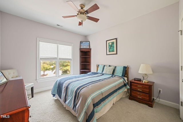 bedroom with ceiling fan and light colored carpet