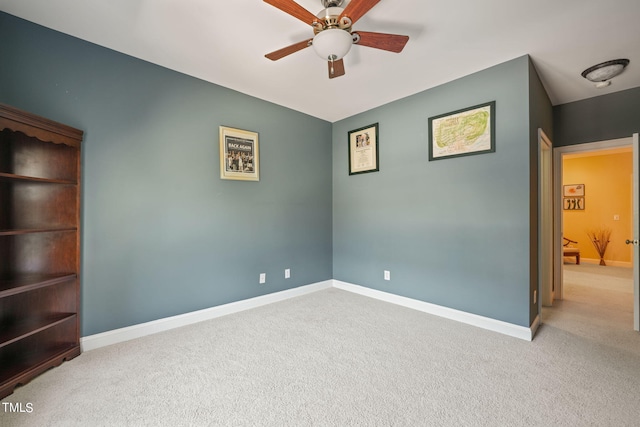 unfurnished room featuring light carpet and ceiling fan