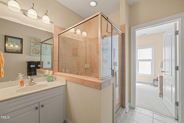 bathroom with vanity, walk in shower, and tile patterned flooring