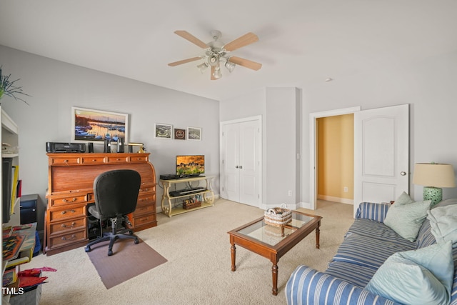 carpeted home office featuring ceiling fan