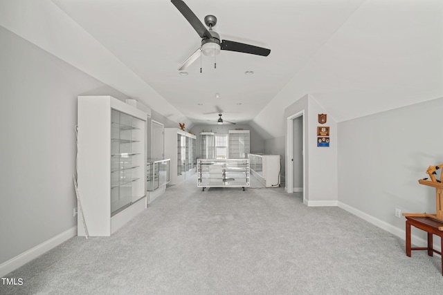 interior space with light carpet and vaulted ceiling