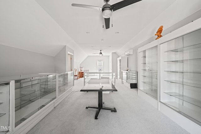 exercise area featuring a wall mounted air conditioner and light colored carpet