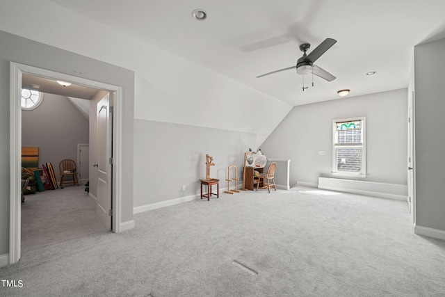 additional living space with light carpet, lofted ceiling, and ceiling fan