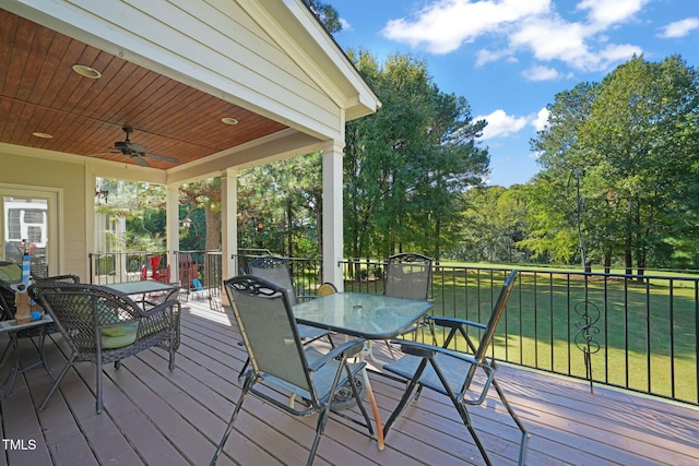 wooden deck with a yard and ceiling fan