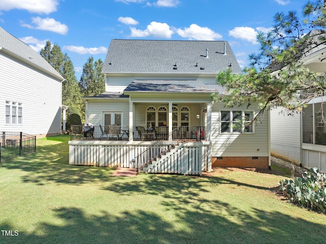 rear view of property featuring a yard and a wooden deck